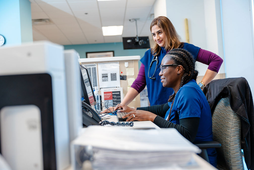 Staff at computer desk.